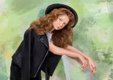 Портрет женский Маслом на абстрактном фоне с использованием широких зеленых мазков разного оттенка и оранжевых вкраплений: девушка с длинными рыжими кудрявыми волосами и веснушками, в черной фетровой шляпе на голове, белой майке и черной кожаной куртке, накинутой на плечи, и юбке, стоит, облокотясь локтями на край стула. Лицо повернуто на зрителя. Художник Софья.